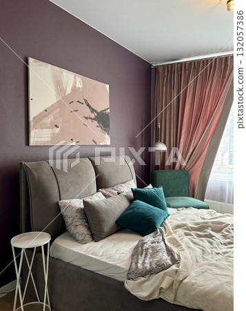 a modern bedroom in a stylish interior of a new apartment with designer renovation 132057386