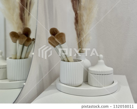 makeup brushes on the women's dressing table in a modern and stylish interior 132058011
