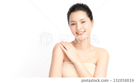 A beautiful young Asian woman with clean, fresh skin against a white background. Skincare, facial treatment, cosmetology, beauty, and spa. An elegant portrait of an Asian woman. 132058019