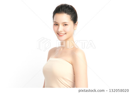 A beautiful young Asian woman with clean, fresh skin against a white background. Skincare, facial treatment, cosmetology, beauty, and spa. An elegant portrait of an Asian woman. 132058020