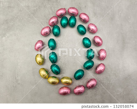 Colorful chocolate easter eggs forming a circle on grey background copy space Colorful chocolate easter eggs forming a circle on grey background copy space 132058074