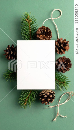 Pine cones and pine needles with blank card on green background 132059240