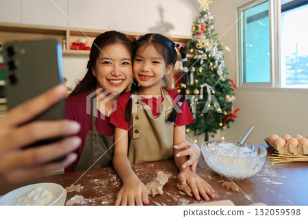 Sweet Memories. Mother and daughter taking a selfie while baking Christmas cookies. Sweet Memories. Mother and daughter taking a selfie while baking Christmas cookies. 132059598