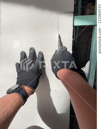 Cutting drywall with utility knife Cutting drywall with utility knife 132060533