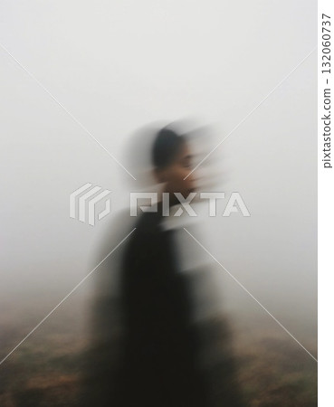 A figure moves through dense fog during early morning, surrounded by a mysterious haze that enhances the ghostly atmosphere of the scene Generative AI A figure moves through dense fog during early morning, surrounded by a mysterious haze that enhances the ghostly atmosphere of the scene Generative AI 132060737