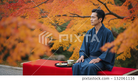 A man in a kimono eating Japanese sweets Autumn leaves 132061116