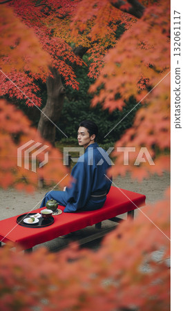 A man in a kimono eating Japanese sweets Autumn leaves 132061117