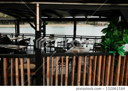 Riverside floating cafe with empty tables and chairs overlooking the Sava River in Belgrade 132061584