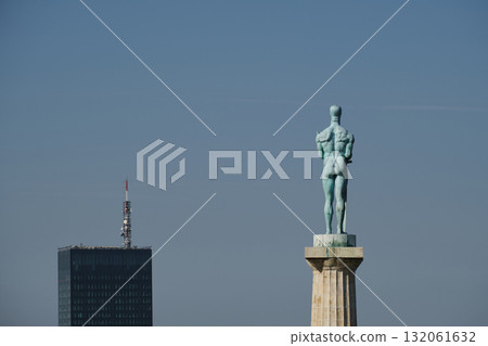 Close-up of Pobednik monument in Kalemegdan Fortress, Belgrade with city tower in background 132061632