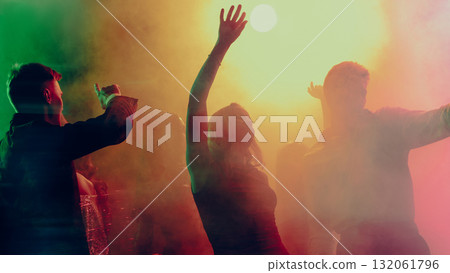 Christmas party woman dancing confidently in spotlight amid vibrant crowd 132061796