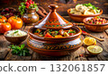 Discover the rich flavors of Moroccan tagine featuring colorful stews and fresh ingredients on a rustic wooden table 132061857