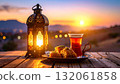 Celebrating Ramadan with tea and baklava under a glowing lantern at sunset 132061858
