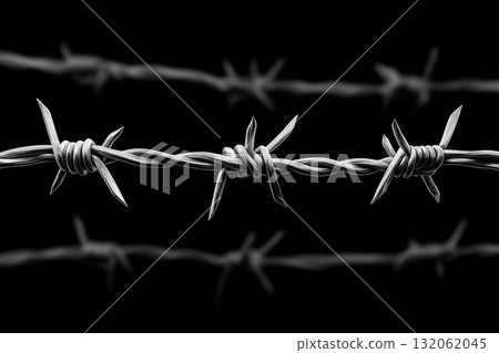 Barbed wire fence with sharp points and twisted strands against a dark background Barbed wire fence with sharp points and twisted strands against a dark background 132062045