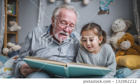 Grandpa reading bedtime stories to granddaughter in cozy bedroom, surrounded by stuffed animals, highlighting multigenerational family connection and love Grandpa reading bedtime stories to granddaughter in cozy bedroom, surrounded by stuffed animals, highlighting multigenerational family connection and love 132062212