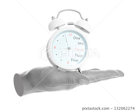 Woman hand holds alarm clock, isolated on transparent background, office and household items concept. Contemporary art concept Woman hand holds alarm clock, isolated on transparent background, office and household items concept. Contemporary art concept 132062274