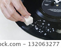 Cleaning dirty old records with detergent and a sponge 132063277