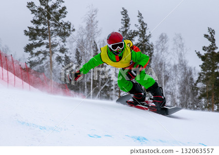 Snowboarder in bright clothes on competition snowboard cross Snowboarder in bright clothes on competition snowboard cross 132063557