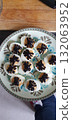 Deviled eggs decorated with black olive spiders for a Halloween party, mobile photo. Fun and spooky homemade snack perfect for seasonal food, celebration, and holiday theme imagery. 132063952