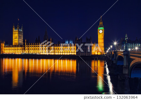 Illuminated Palace of Westminster and Elizabeth Tower reflecting in River Thames at night in London Illuminated Palace of Westminster and Elizabeth Tower reflecting in River Thames at night in London 132063964