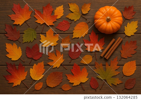 Autumn leaves, pumpkin, and cinnamon sticks on wooden background, seasonal decoration for fall. 132064285