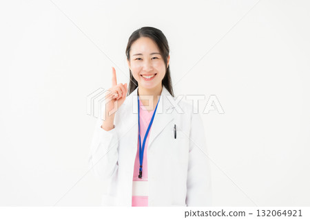 Business woman in white scrubs pointing Business woman in white scrubs pointing 132064921