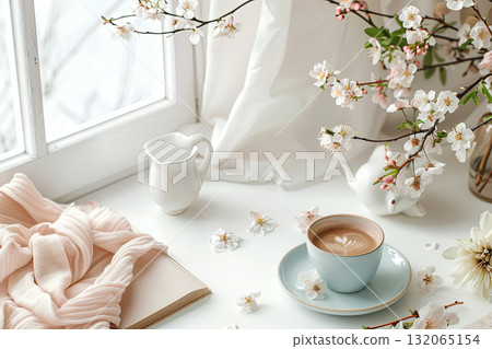 White table with a cup of coffee, a white pitcher, a white plate and white blanket near windows White table with a cup of coffee, a white pitcher, a white plate and white blanket near windows 132065154