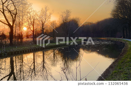 Serene Sunset Reflections by the Water, showcasing the beautiful blend of colors and light Serene Sunset Reflections by the Water, showcasing the beautiful blend of colors and light 132065436