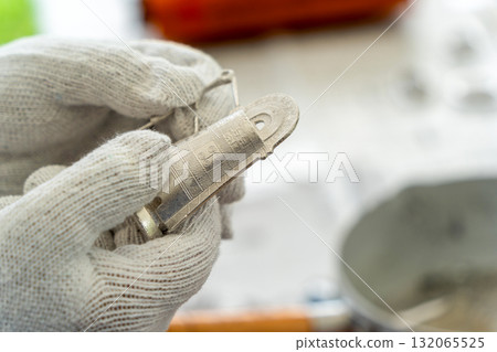 Making a mini bronze bell: Removing it from the mold 132065525