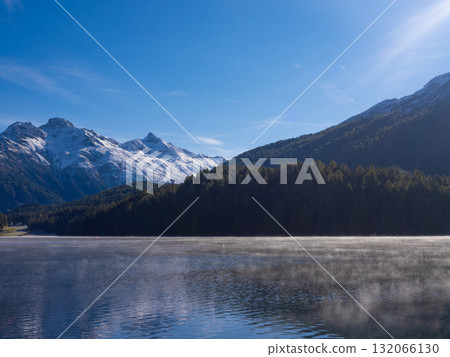 St. Moritz, Switzerland - October 6th 2024: Early morning view over lake SIlvaplana towards high mountains St. Moritz, Switzerland - October 6th 2024: Early morning view over lake SIlvaplana towards high mountains 132066130
