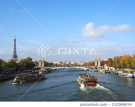 Scenery of Paris, France. The Seine River and the Eiffel Tower. The beautiful autumn blue sky overlooking the Pont Alexandre III across the Seine. Scenery of Paris, France. The Seine River and the Eiffel Tower. The beautiful autumn blue sky overlooking the Pont Alexandre III across the Seine. 132066654