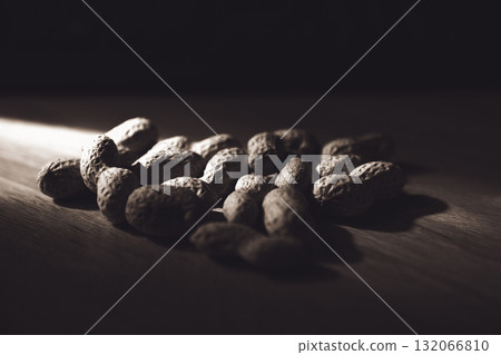 Dramatic Low Key Monochrome Peanuts in Shell on Wooden Surface 132066810