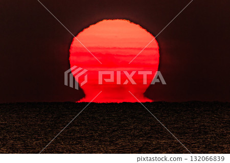 A fantastical Daruma sunrise appearing on the sea surface 132066839