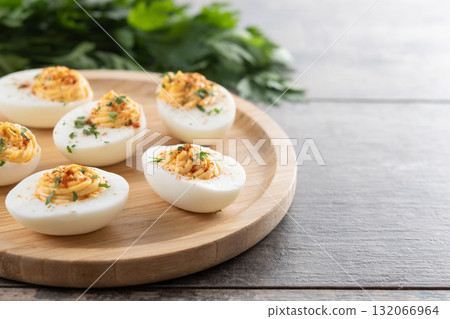 Homemade hard Boiled Deviled Eggs garnished with herbs 132066964