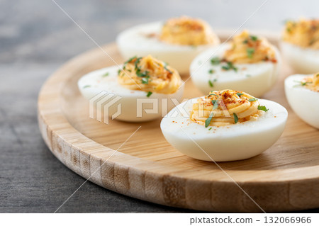 Homemade hard Boiled Deviled Eggs garnished with herbs 132066966
