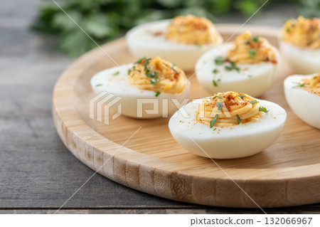 Homemade hard Boiled Deviled Eggs garnished with herbs 132066967