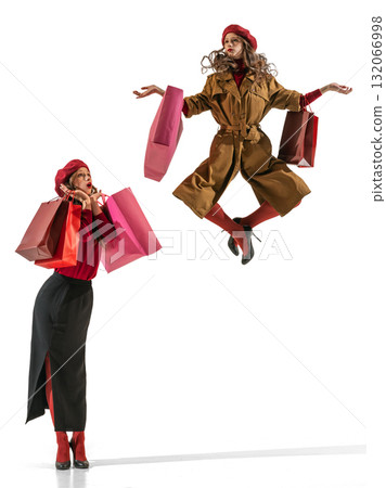 Stylish woman jumping with shopping bags expressing elegance and retail joy Stylish woman jumping with shopping bags expressing elegance and retail joy 132066998