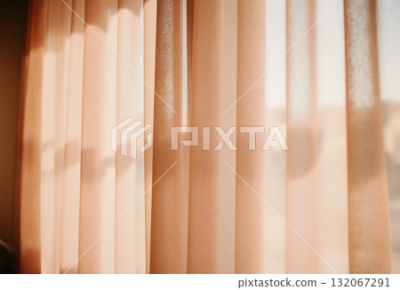 Natural light streams through sheer brown beige peach curtains, creating a tranquil vibe in a cozy living area. The softness of the fabric adds charm to the space Generative AI 132067291