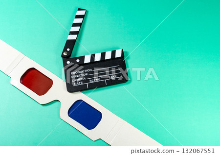 A cinematic composition featuring a clapperboard and 3D glasses against a vibrant, teal background, perfect for movie and cinema themes. A cinematic composition featuring a clapperboard and 3D glasses against a vibrant, teal background, perfect for movie and cinema themes. 132067551