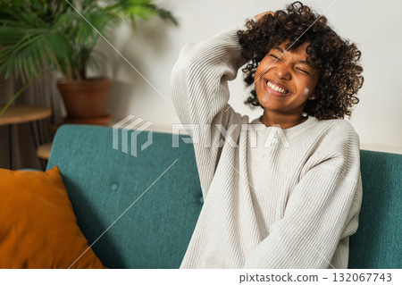 Beautiful African American girl with afro hairstyle smiling. Close up portrait of young happy black girl. Young African woman with curly hair laughing. Freedom happiness carefree happy people concept Beautiful African American girl with afro hairstyle smiling. Close up portrait of young happy black girl. Young African woman with curly hair laughing. Freedom happiness carefree happy people concept 132067743