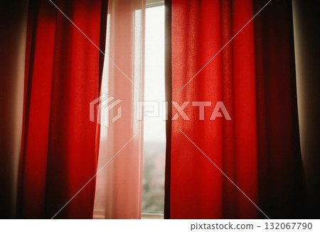 Bright red curtains hang on either side of a window, softly filtering sunlight into a cozy room. The warm glow enhances the comfortable ambiance, perfect for relaxation Generative AI Bright red curtains hang on either side of a window, softly filtering sunlight into a cozy room. The warm glow enhances the comfortable ambiance, perfect for relaxation Generative AI 132067790