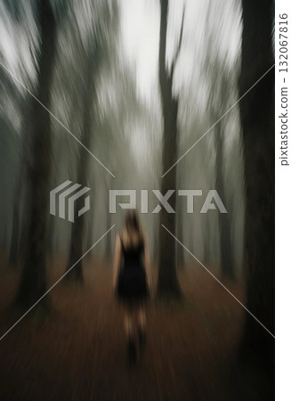 In a spooky forest, a ghostly woman appears to walk away, surrounded by tall trees shrouded in mist. The scene is filled with an unsettling mood and dim lighting Generative AI 132067816