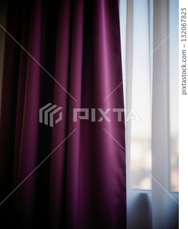 Elegant purple lilac curtains hang by the window, allowing soft natural light to enter the room, creating a calm and inviting atmosphere during the day Generative AI 132067825
