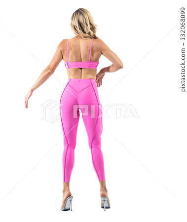 Athletic woman smiling, posing in pink fitness outfiton on transparent background Athletic woman smiling, posing in pink fitness outfiton on transparent background 132068099