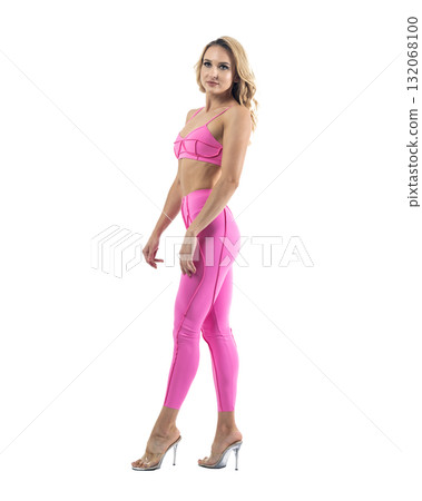 Athletic woman smiling, posing in pink fitness outfiton on transparent background Athletic woman smiling, posing in pink fitness outfiton on transparent background 132068100