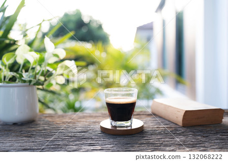 americano coffee glass cup and old book on rustic wooden table americano coffee glass cup and old book on rustic wooden table 132068222