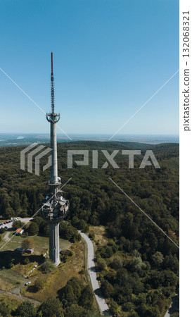 Aerial view of TV tower Iriski Venac rising above the forested hills of Fruska Gora National Park with panoramic landscapes. Was damaged by a NATO missile during the Yugoslav War Aerial view of TV tower Iriski Venac rising above the forested hills of Fruska Gora National Park with panoramic landscapes. Was damaged by a NATO missile during the Yugoslav War 132068321