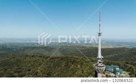 Aerial view of TV tower Iriski Venac rising above the forested hills of Fruska Gora National Park with panoramic landscapes. Was damaged by a NATO missile during the Yugoslav War Aerial view of TV tower Iriski Venac rising above the forested hills of Fruska Gora National Park with panoramic landscapes. Was damaged by a NATO missile during the Yugoslav War 132068322