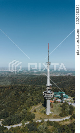 Aerial view of TV tower Iriski Venac rising above the forested hills of Fruska Gora National Park with panoramic landscapes. Was damaged by a NATO missile during the Yugoslav War Aerial view of TV tower Iriski Venac rising above the forested hills of Fruska Gora National Park with panoramic landscapes. Was damaged by a NATO missile during the Yugoslav War 132068323
