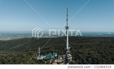 Aerial view of TV tower Iriski Venac rising above the forested hills of Fruska Gora National Park with panoramic landscapes. Was damaged by a NATO missile during the Yugoslav War Aerial view of TV tower Iriski Venac rising above the forested hills of Fruska Gora National Park with panoramic landscapes. Was damaged by a NATO missile during the Yugoslav War 132068328