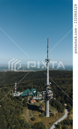 Aerial view of TV tower Iriski Venac rising above the forested hills of Fruska Gora National Park with panoramic landscapes. Was damaged by a NATO missile during the Yugoslav War Aerial view of TV tower Iriski Venac rising above the forested hills of Fruska Gora National Park with panoramic landscapes. Was damaged by a NATO missile during the Yugoslav War 132068329